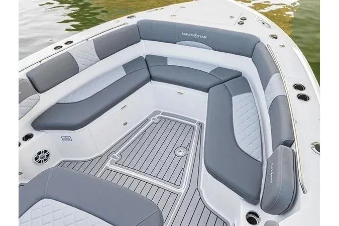 Slide: The Image of 2025 NauticStar 332 Offshore boat docked at marina, featuring sleek blue design. - 4