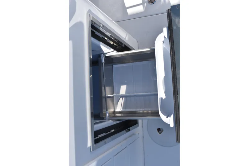 Slide: The Image of Open storage compartment on 2025 NauticStar 332 Offshore boat. - 40