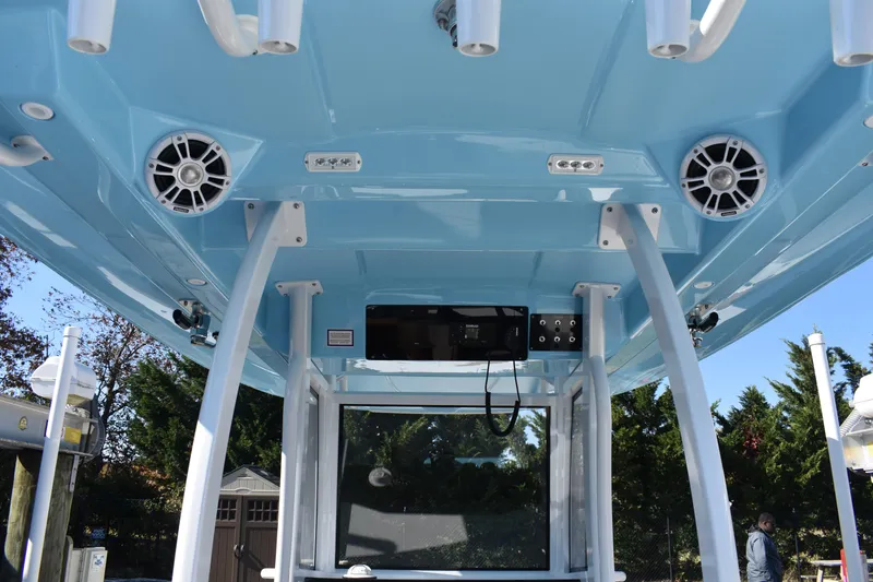 Slide: The Image of 2025 NauticStar 332 Offshore boat interior with speakers and electronic controls. - 44