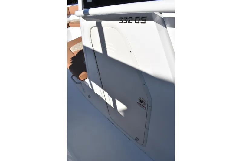 Slide: The Image of 2025 NauticStar 332 Offshore boat interior detail with seating and storage compartment. - 57