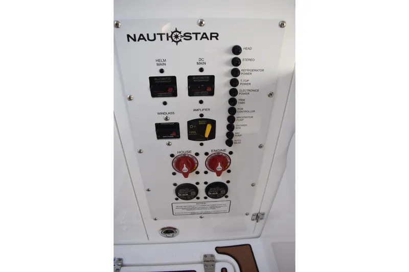 Slide: The Image of Control panel of 2025 NauticStar 332 Offshore boat with various switches and dials. - 60