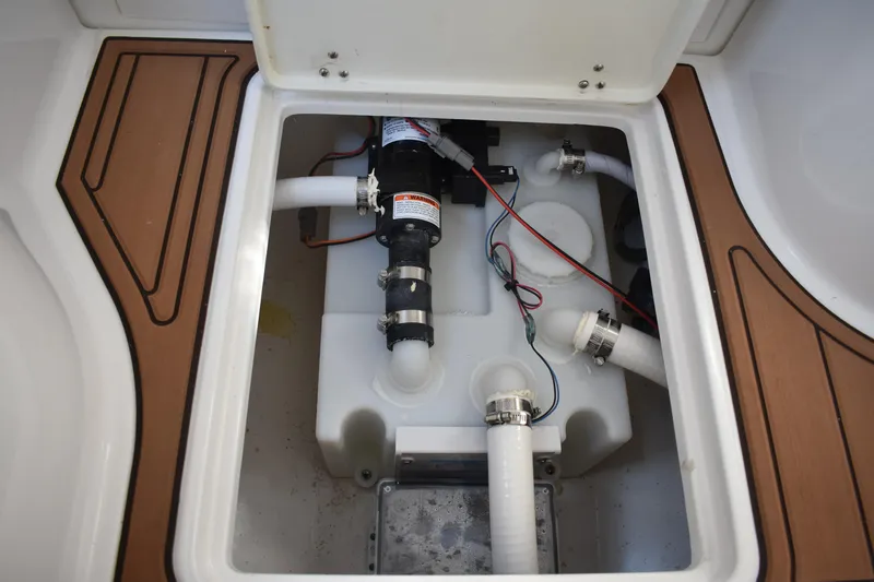 Slide: The Image of 2025 NauticStar 332 Offshore boat plumbing system with pump and hoses. - 65