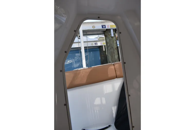 Slide: The Image of Interior view of 2025 NauticStar 332 Offshore boat, showcasing seating and dockside perspective. - 66