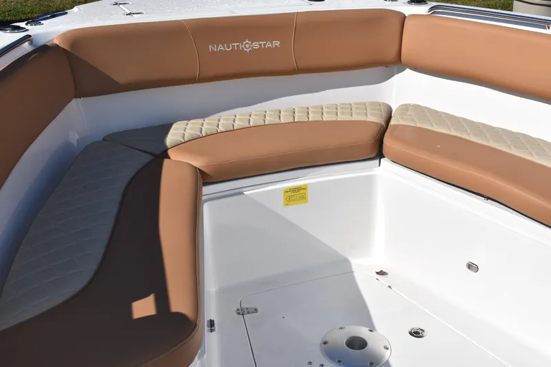 Slide: The Image of 2025 NauticStar 332 Offshore boat with tan cushioned seating in the bow area. - 67