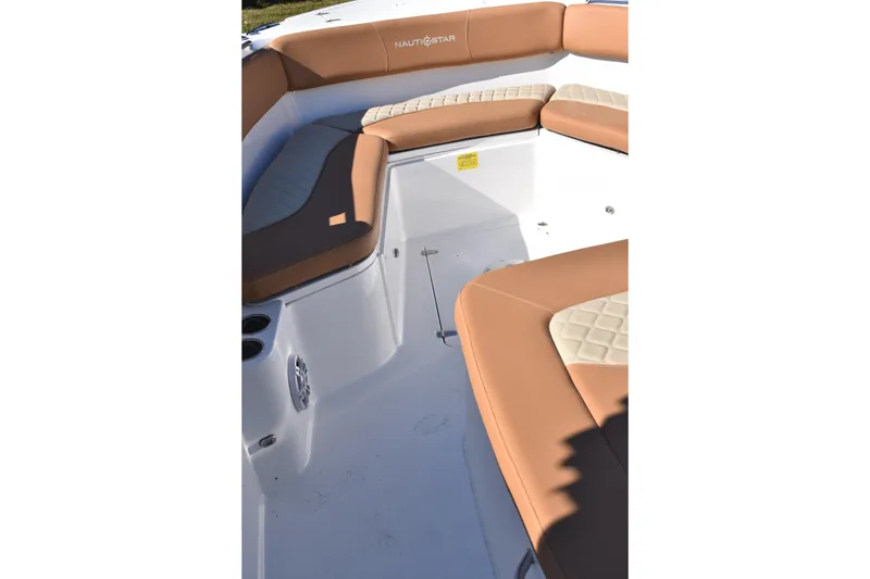 Slide: The Image of 2025 NauticStar 332 Offshore boat interior with tan seating and cup holders. - 69