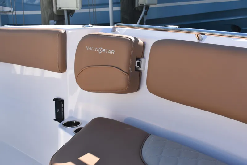Slide: The Image of 2025 NauticStar 332 Offshore boat interior with brown cushioned seating. - 71