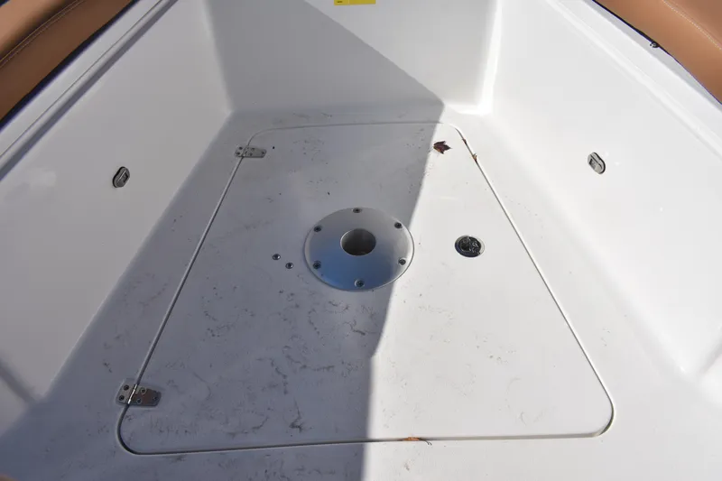 Slide: The Image of 2025 NauticStar 332 Offshore boat deck with storage compartment and clean white finish. - 80