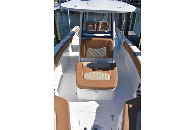 Slide: The Image of 2025 NauticStar 332 Offshore boat interior with tan seating and white deck. - 85