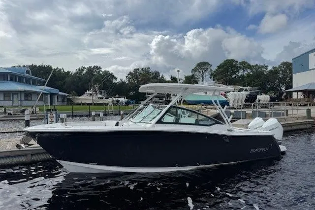 Slide: The Image of 2025 Blackfin 272 DC boat cruising on water, aerial view. - 1