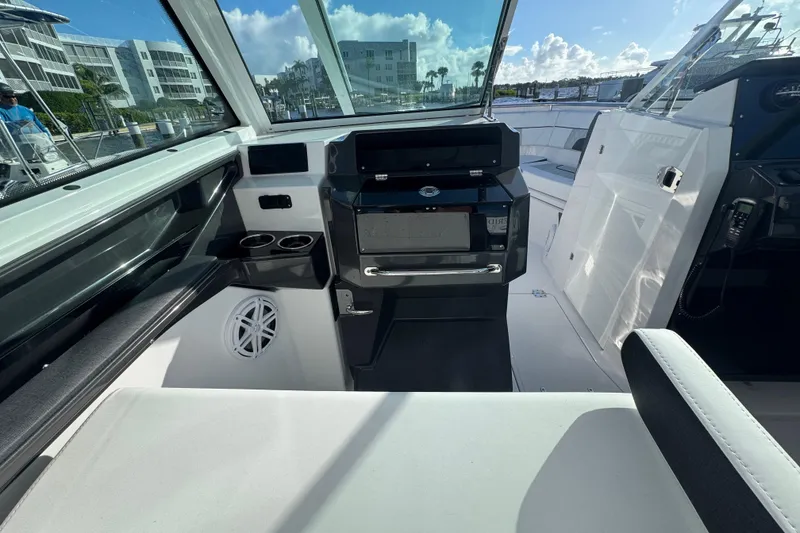 Slide: The Image of 2025 Blackfin 272DC boat docked at marina under cloudy sky. - 11