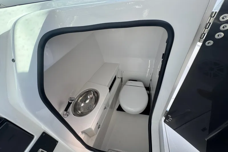 Slide: The Image of 2025 Blackfin 272DC boat docked with twin 300 horsepower engines. - 12