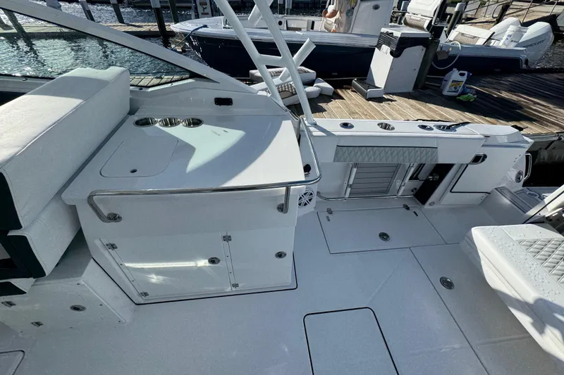 Slide: The Image of 2025 Blackfin 272 DC boat interior with seating and storage, on a sunny day at sea. - 14