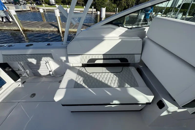 Slide: The Image of 2025 Blackfin 272 DC boat interior with open storage drawer by the water. - 18