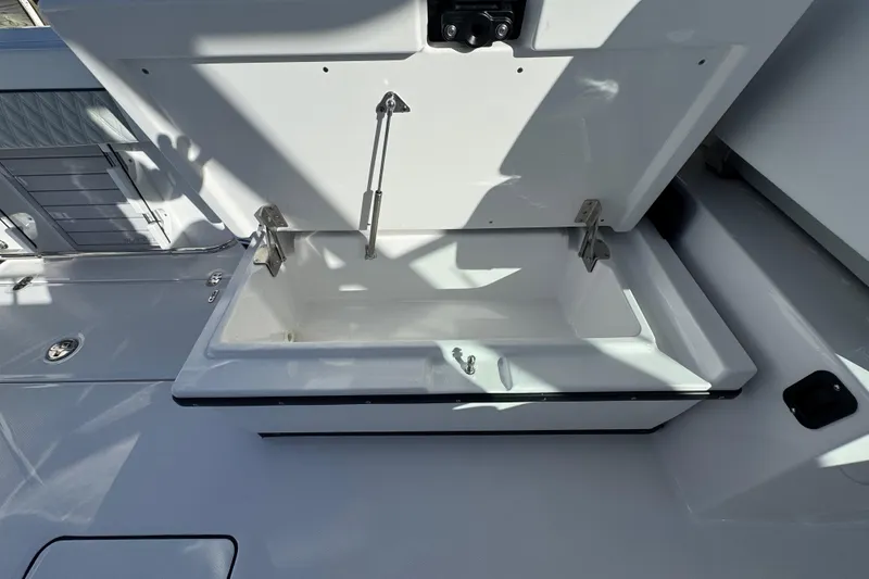 Slide: The Image of 2025 Blackfin 272 DC boat interior with open storage drawer on deck. - 19