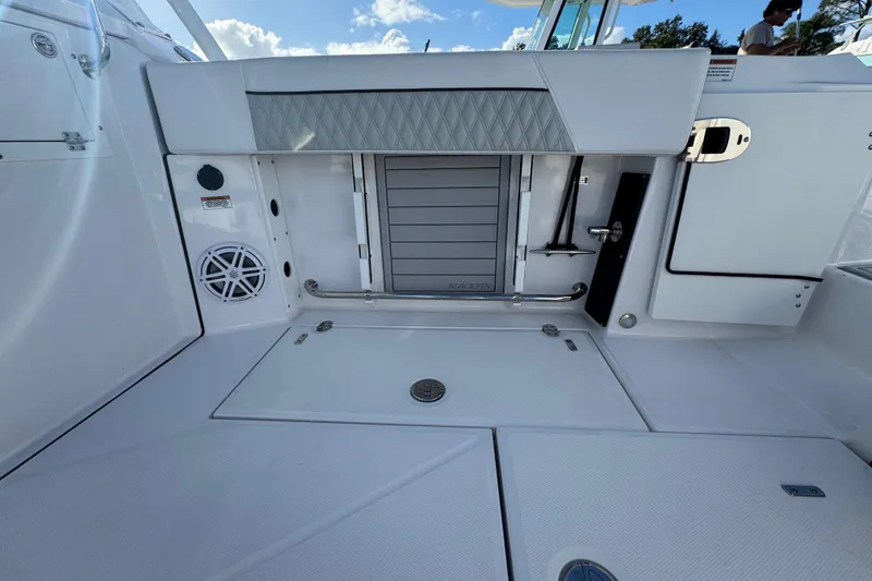 Slide: The Image of 2025 Blackfin 272 DC boat interior with view of water and engine. - 24