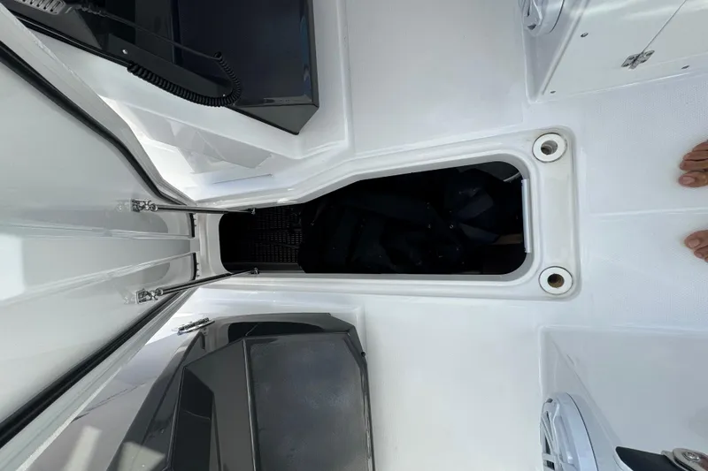 Slide: The Image of 2025 Blackfin 272 DC boat interior with seating and storage, on a sunny day at sea. - 29