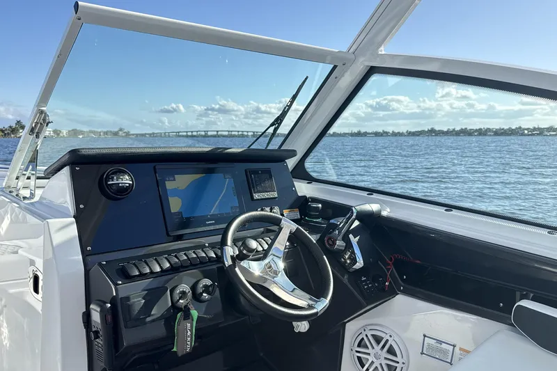 Slide: The Image of 2025 Blackfin 272 DC boat interior with luxurious seating and steering wheel. - 36