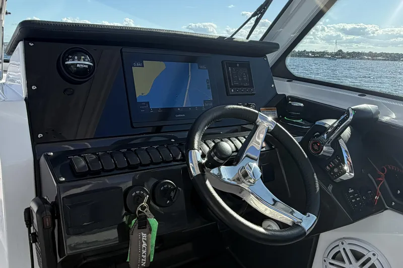 Slide: The Image of 2025 Blackfin 272 DC boat interior with storage compartment and cup holders. - 38