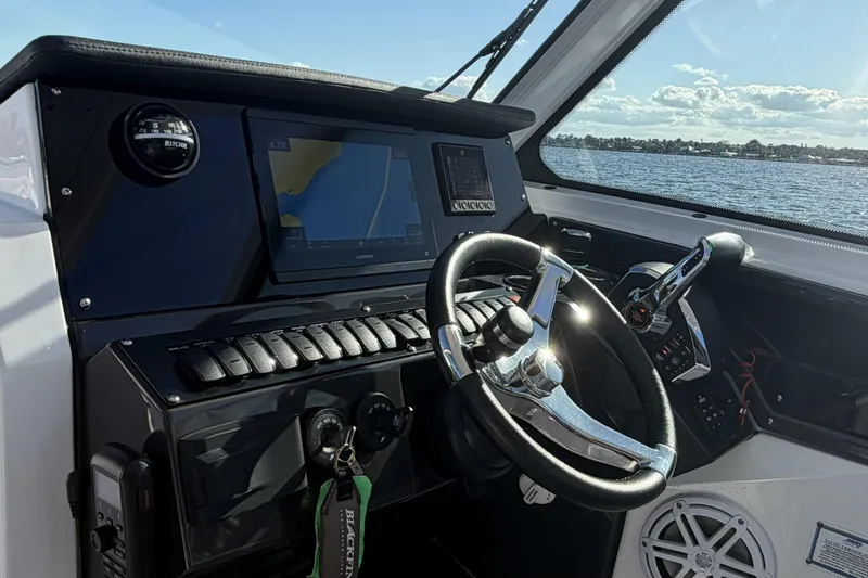 Slide: The Image of 2025 Blackfin 272 DC boat dashboard with sleek design and modern controls. - 39