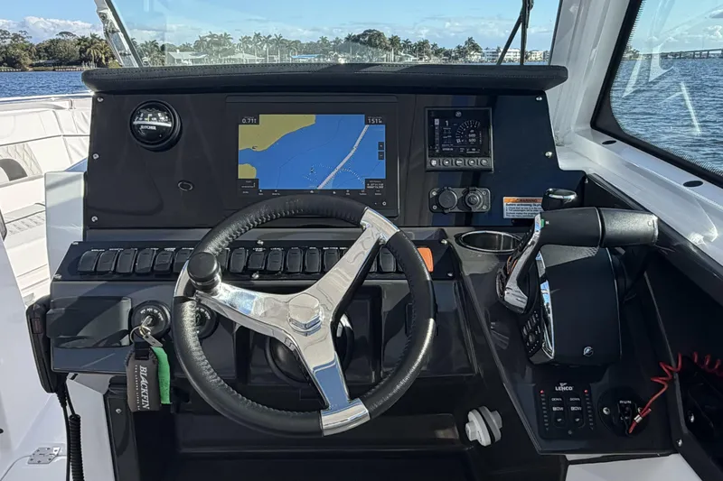Slide: The Image of Interior view of 2025 Blackfin 272 DC boat, featuring sleek dashboard and seating area. - 40