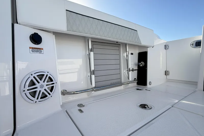 Slide: The Image of Interior of 2025 Blackfin 272 DC boat showing control panel and storage area. - 59