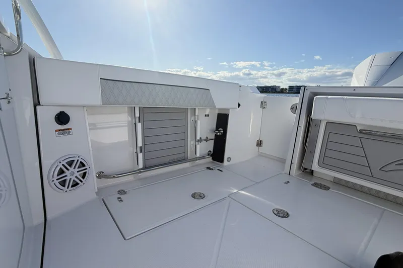 Slide: The Image of Interior view of 2025 Blackfin 272 DC boat, featuring control panel and storage area. - 60
