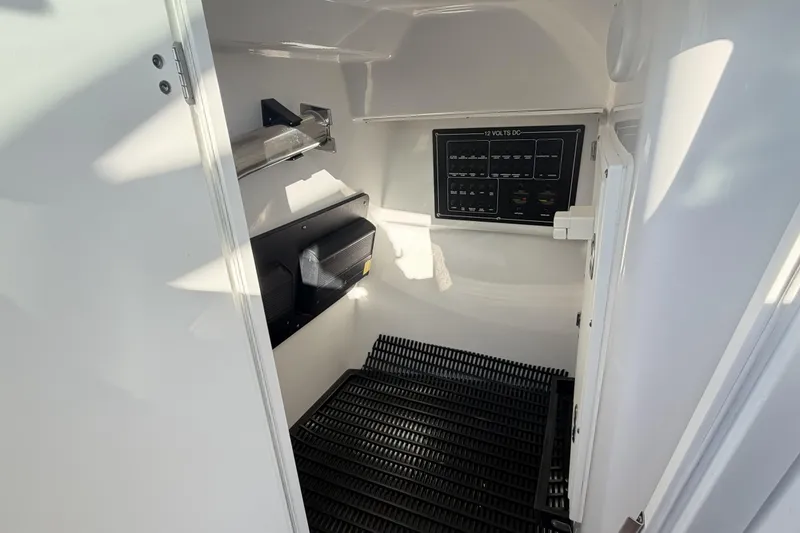 Slide: The Image of Interior of 2025 Blackfin 272 DC boat showing electrical panel and storage area. - 64