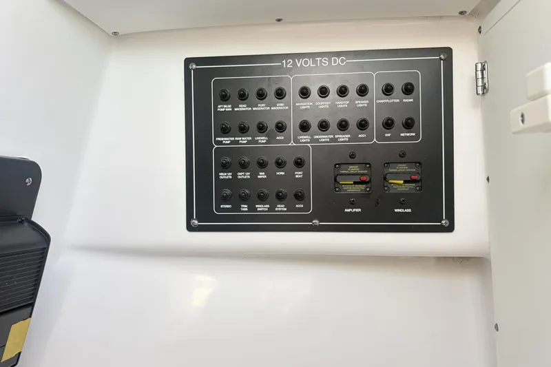 Slide: The Image of 2025 Blackfin 272 DC boat interior with white cushioned seating and speaker. - 68