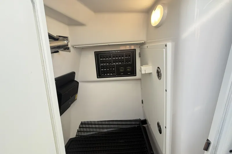 Slide: The Image of 2025 Blackfin 272 DC boat interior with white cushioned seating and sleek design. - 69