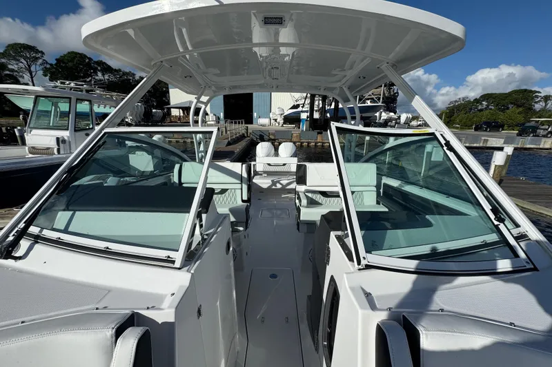 Slide: The Image of 2025 Blackfin 272 DC boat on calm water near a dock. - 7