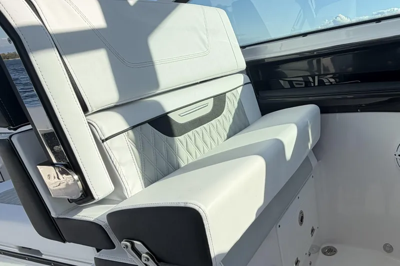 Slide: The Image of 2025 Blackfin 272 DC boat with luxurious white seating and scenic water view. - 71