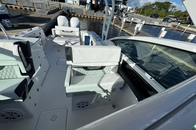 Slide: The Image of 2025 Blackfin 272 DC boat on water, sleek design, dual engines, white and black color scheme. - 8
