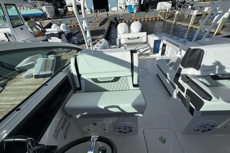 Slide: The Image of 2025 Blackfin 272 DC boat docked on calm water, showcasing sleek design and modern features. - 9