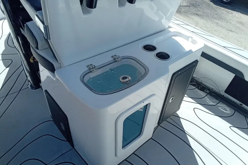Slide: The Image of 2023 Tidewater 2700 Carolina Bay boat interior with storage and cup holders. - 11