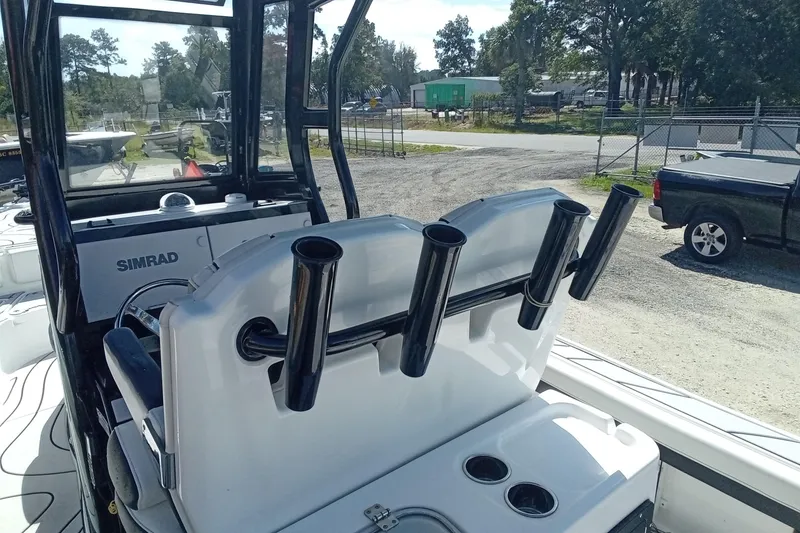 Slide: The Image of 2023 Tidewater 2700 Carolina Bay boat interior with rod holders and Simrad electronics. - 12