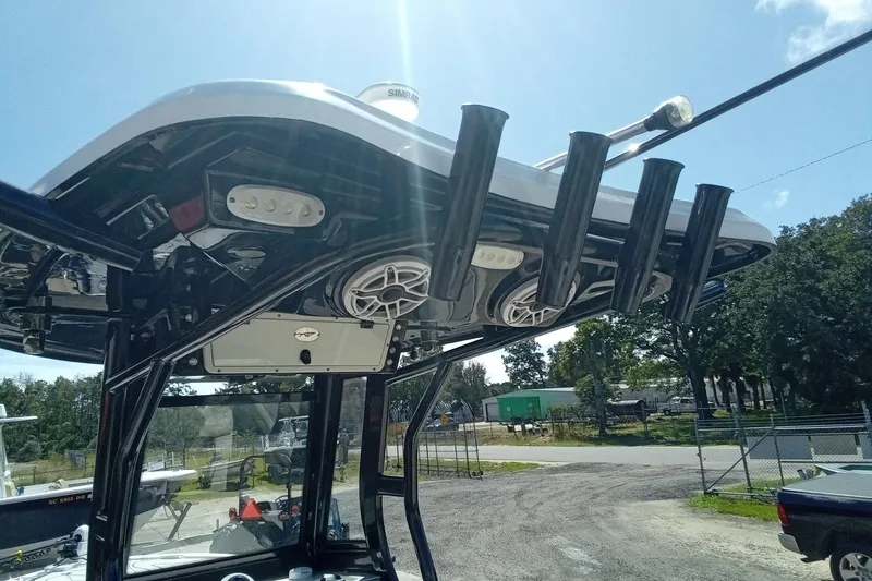 Slide: The Image of 2023 Tidewater 2700 Carolina Bay boat with rod holders and speakers on the T-top. - 13