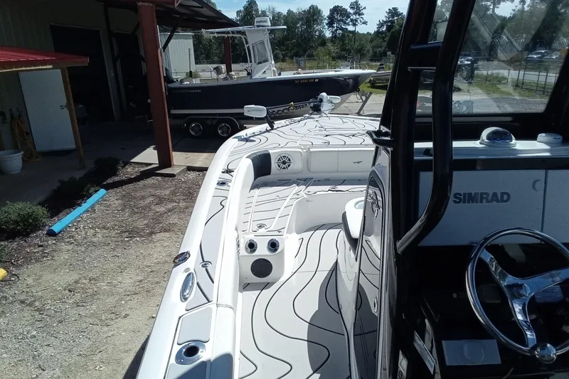 Slide: The Image of 2023 Tidewater 2700 Carolina Bay boat with Simrad electronics, parked outdoors. - 14