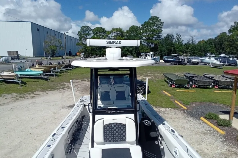 Slide: The Image of 2023 Tidewater 2700 Carolina Bay boat with Simrad radar, parked outdoors. - 18