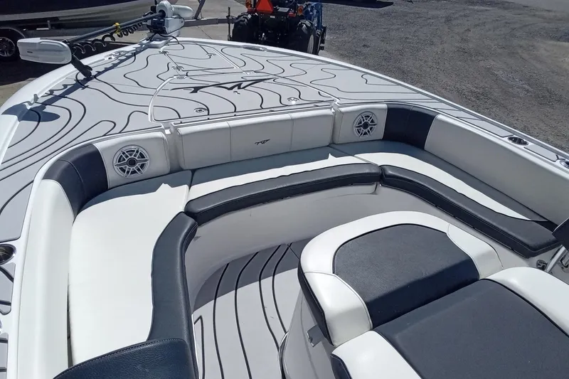 Slide: The Image of 2023 Tidewater 2700 Carolina Bay boat interior with cushioned seating and speakers. - 20