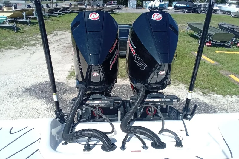 Slide: The Image of 2023 Tidewater 2700 Carolina Bay boat with dual outboard motors, parked on a trailer. - 24