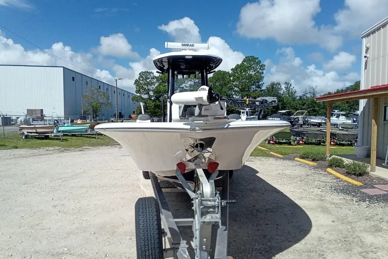 Slide: The Image of 2023 Tidewater 2700 Carolina Bay boat on trailer, parked outdoors under blue sky. - 27