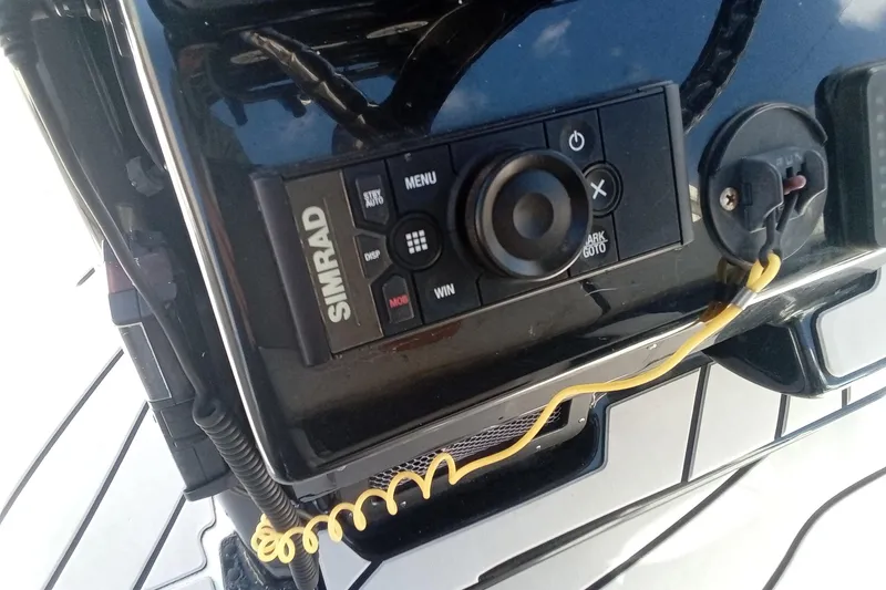 Slide: The Image of Simrad control panel on 2023 Tidewater 2700 Carolina Bay boat dashboard. - 4