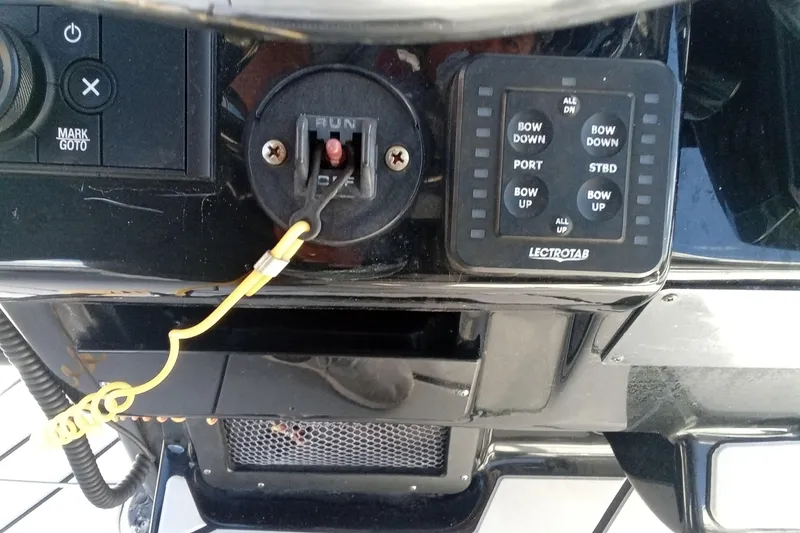 Slide: The Image of Control panel of 2023 Tidewater 2700 Carolina Bay boat with Lectrotab trim tab switches. - 5
