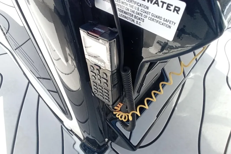 Slide: The Image of Simrad radio on 2023 Tidewater 2700 Carolina Bay boat, featuring safety certification label. - 6