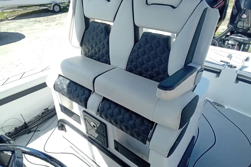 Slide: The Image of 2023 Tidewater 2700 Carolina Bay boat seats with black and gray upholstery. - 7