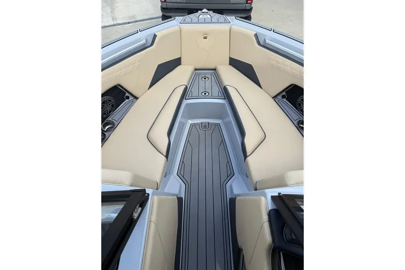 Slide: The Image of 2024 Nautique Super Air Nautique S23 interior with beige seating and sleek design. - 10