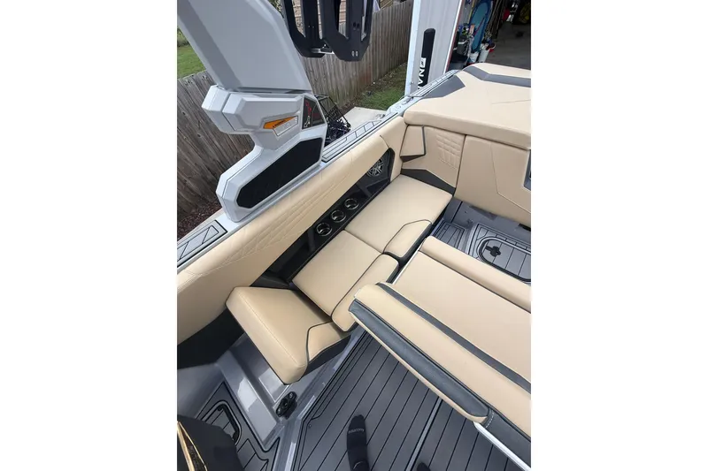 Slide: The Image of 2024 Nautique Super Air Nautique S23 interior with beige seating and modern design. - 12