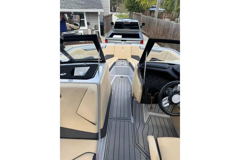 Slide: The Image of 2024 Nautique Super Air Nautique S23 interior with sleek design and luxurious seating. - 14