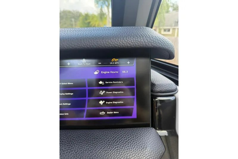 Slide: The Image of 2024 Nautique Super Air Nautique S23 dashboard display showing engine hours and settings. - 2