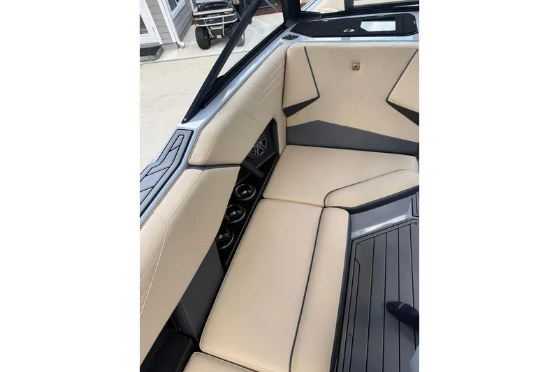 Slide: The Image of 2024 Nautique Super Air Nautique S23 interior with beige seating and sleek design. - 8